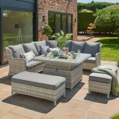 Corner sofa with 2 bench seats and table grey rattan and grey cushions photographed on patio