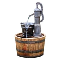 wooden barrel water fountain with a metal water pump and bucket on the top